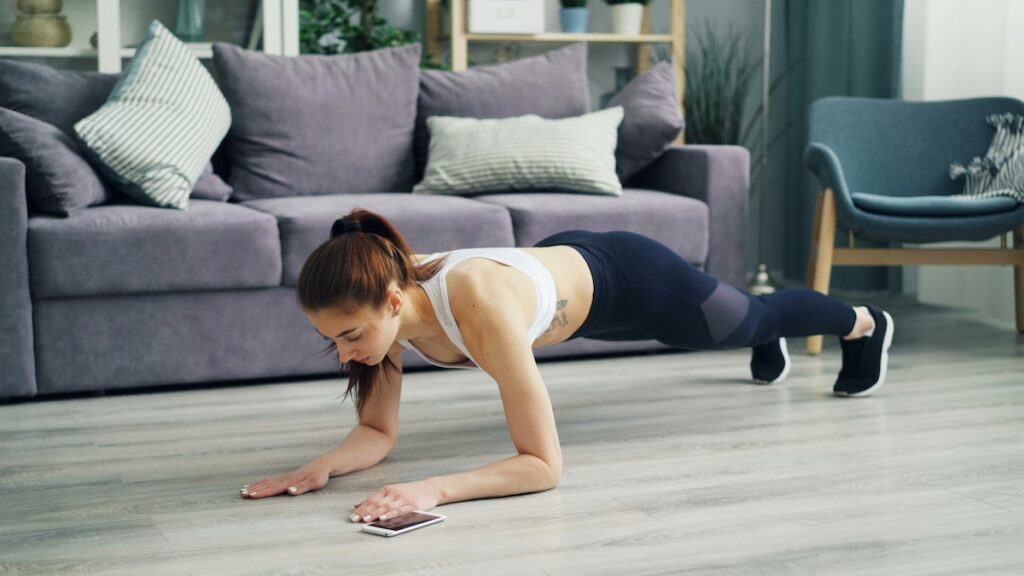 a woman holds a plank as part of a 5 minute core workout
