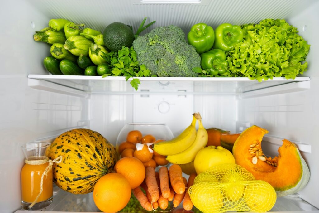 Refrigerator stocked with bananas and other fresh produce from the Clean Fifteen list