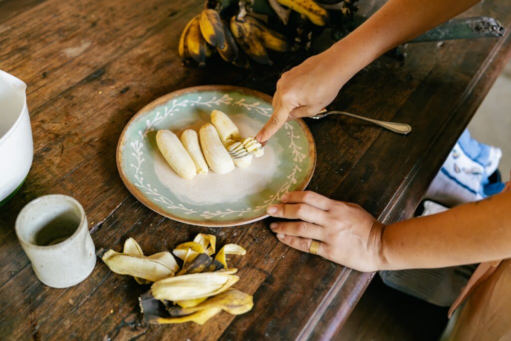 fresh bananas next to discarded peels, showing what's left behind when eating banana peels isn't part of the routine