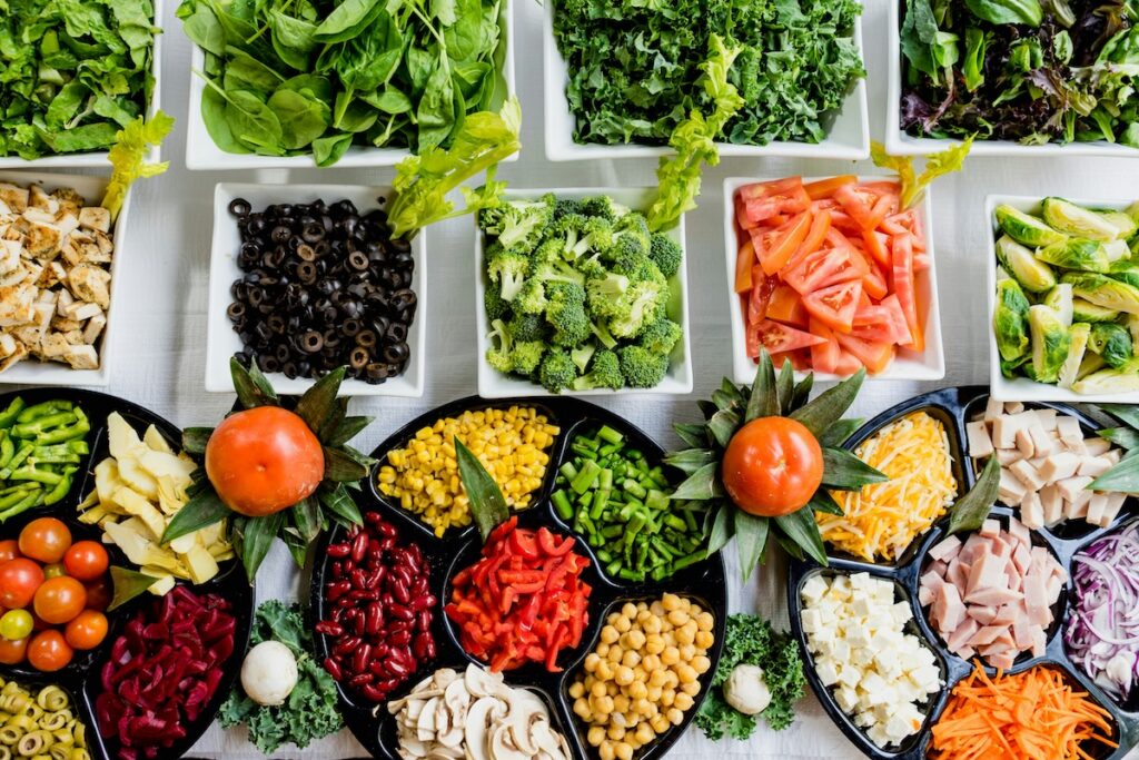 Colorful spread of vegetables, legumes, and lean protein, examples of foods for liver health and disease prevention