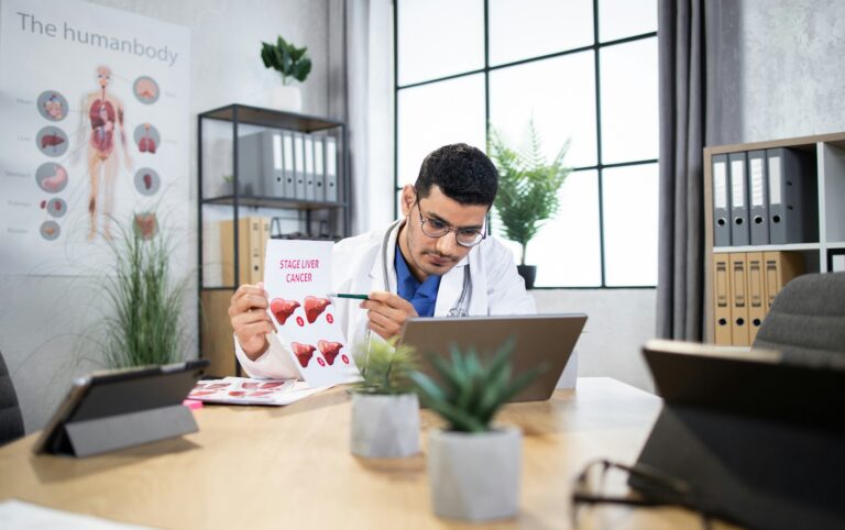 a doctor reviewing stage liver cancer chart, part of foods for liver health research on diet and disease prevention