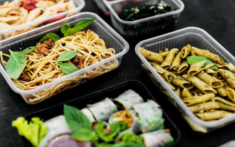 Hot pasta and takeaway meals in plastic containers, a common way microplastics in your kitchen end up in food