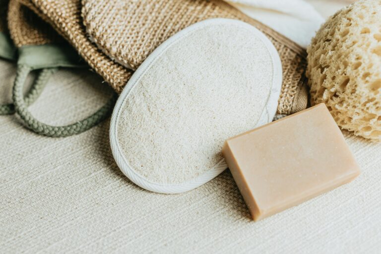 Loofah bacteria can build up in natural sponges like this one, shown here beside a bar of soap and woven bath accessories.