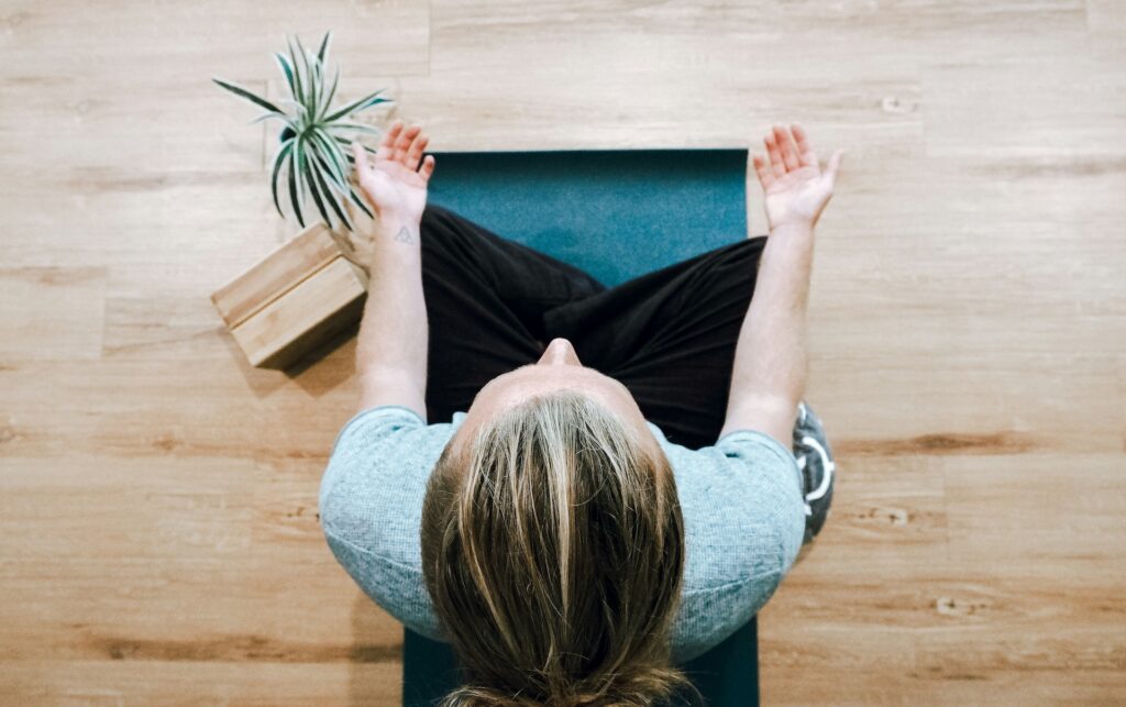 a woman meditates using box breathing to calm the nervous system
