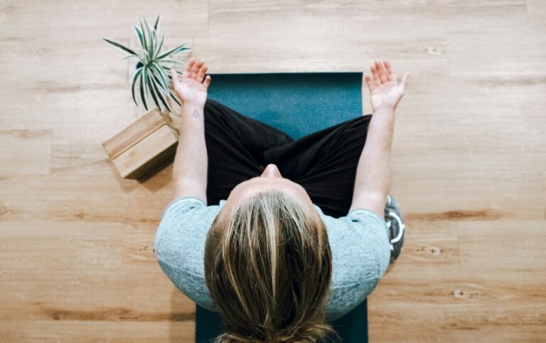 a woman meditates using box breathing to calm the nervous system