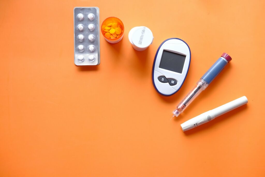 Diabetes medications, glucose monitor, and insulin pens, a reminder to check blood sugar before trying a cortisol cocktail recipe