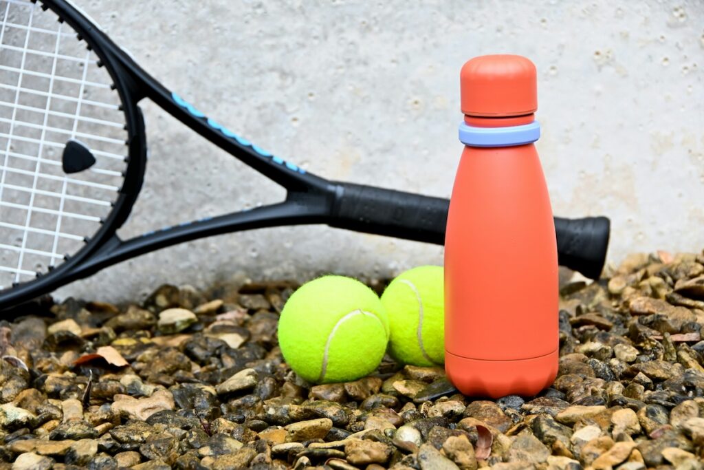 Orange silicone water bottle with tennis gear, related to does silicone have microplastics from heat exposure