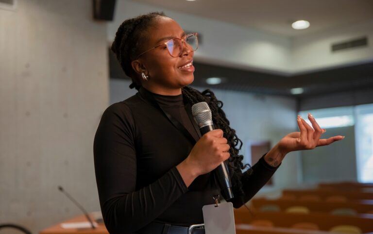 Woman speaking into a microphone, reflecting the connection between speech patterns and brain health