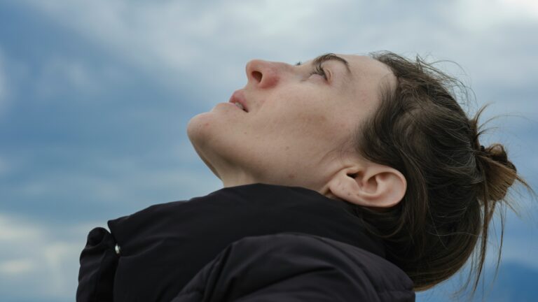 a woman practices vagus nerve breathing to calm her nervous system