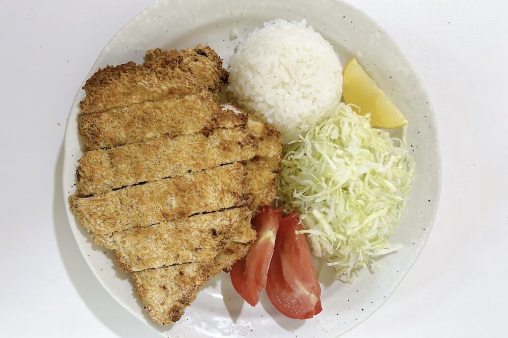 Sliced air fryer chicken katsu with wasabi yogurt sauce, rice, and shredded cabbage, one of this week's easy meals under 30 minutes