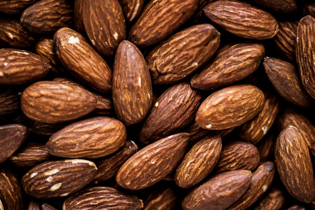 Close-up texture of raw whole almonds, the healthiest nut you can add to your diet