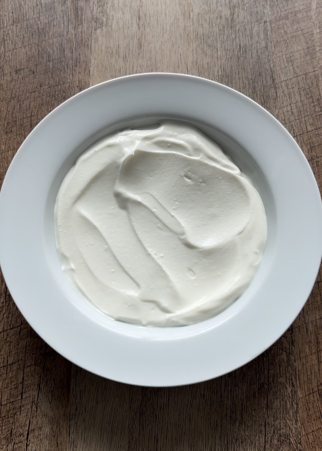 Creamy Greek yogurt spread in a bowl, the base for a peach compote yogurt bowl.