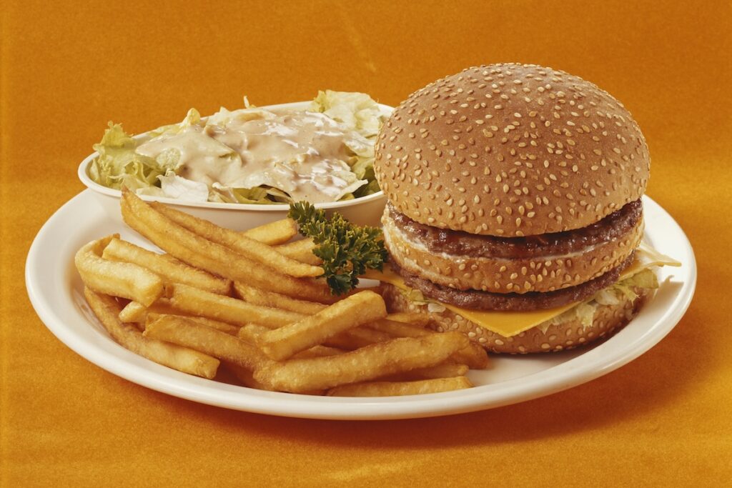 Double cheeseburger with fries, a food to limit on a cortisol detox diet