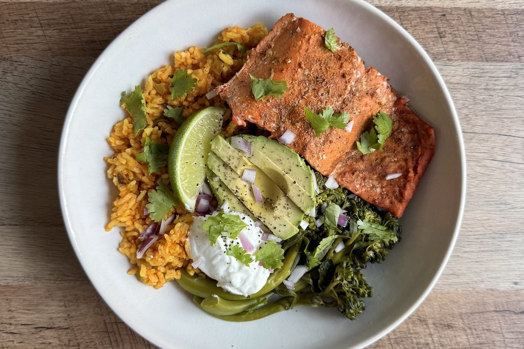Spiced salmon taco bowl with Spanish rice, avocado, broccolini, lime, and yogurt, one of six high protein meals on Better Plates.