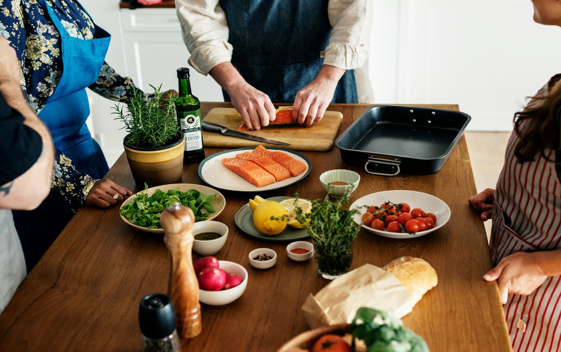 Salmon fillets, fresh greens, and vegetables on a kitchen table, the best food for blood pressure.