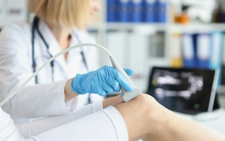 Doctor performing a leg ultrasound to check for signs of a blood clot